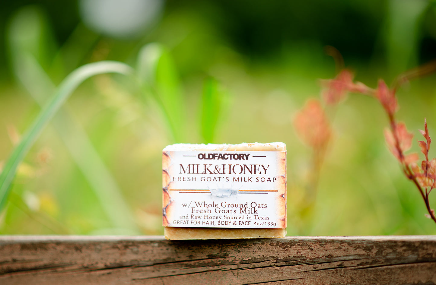 the healthy promise soap handcrafted all natural goats milk and honey front view on a wooden fence