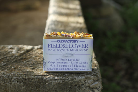 the healthy promise soap handcrafted goats milk field and flower front on stone wall