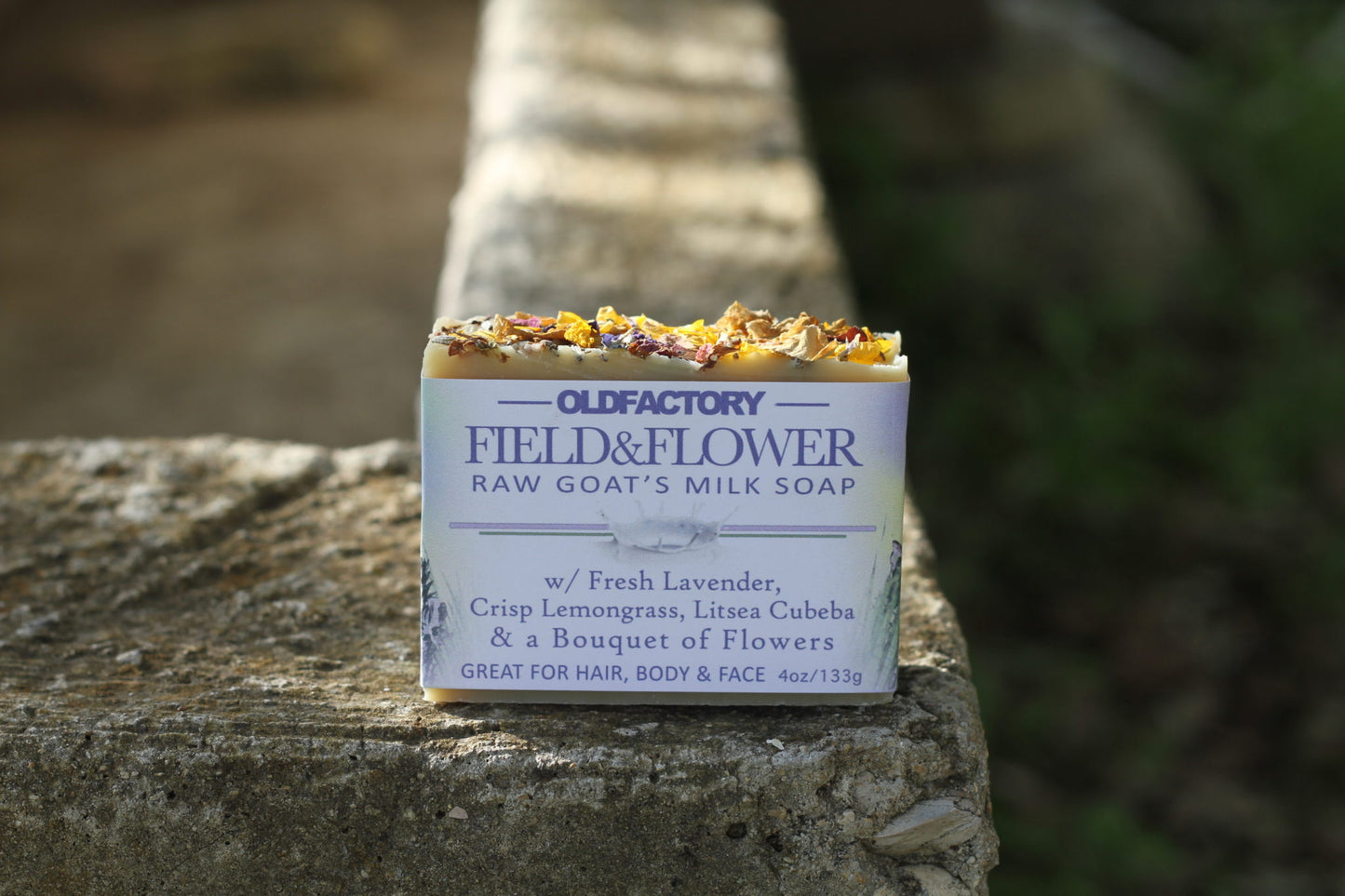 the healthy promise soap handcrafted goats milk field and flower front on stone wall