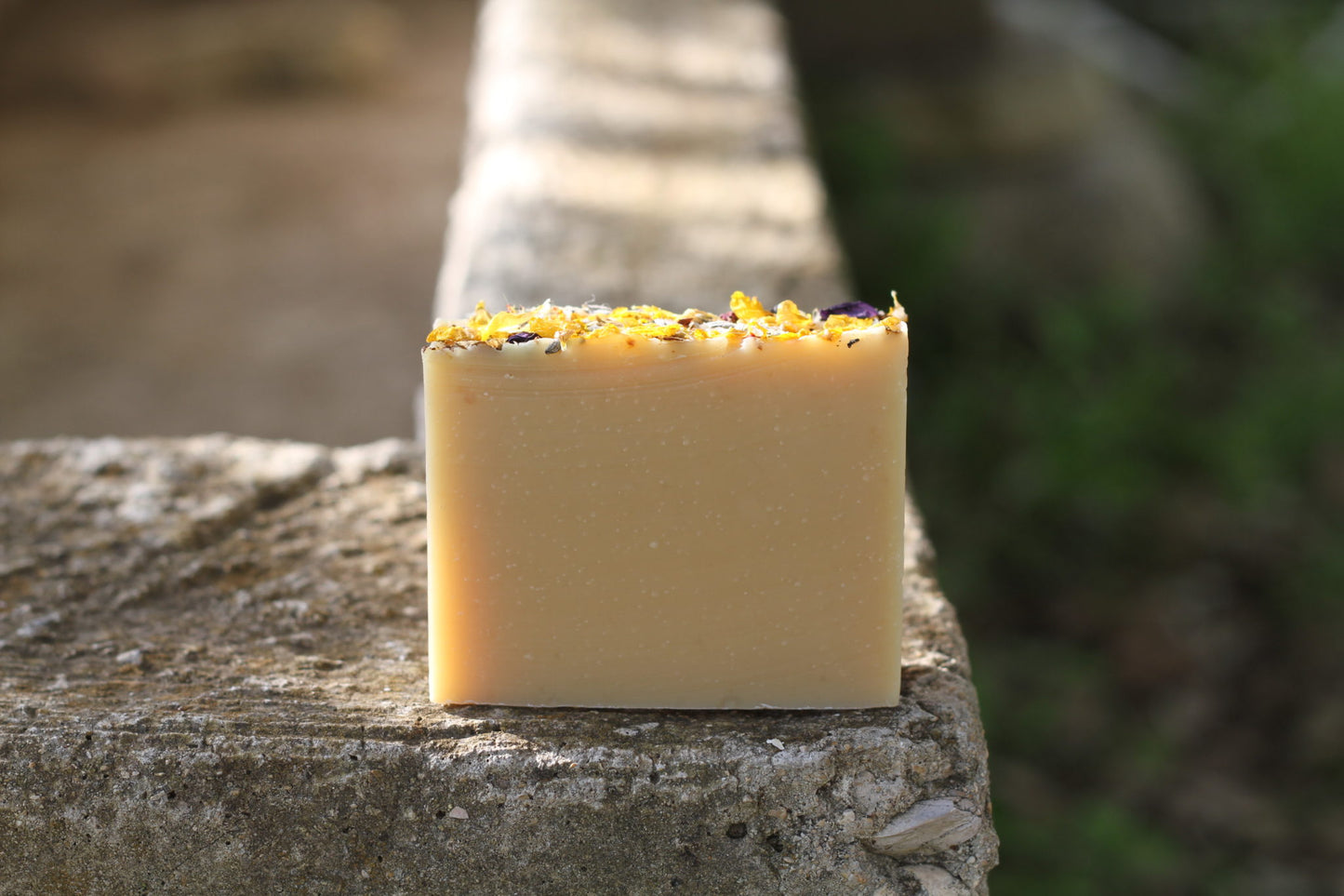 the healthy promise soap handcrafted goats milk field and flower back on stone wall